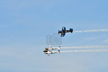 Photo for Zeltweg, Austria - September 03, 2022: Public airshow in Styria named Airpower 22, flight demonstration with two WWII fighter aircrafts, Chance Vought F4U-4 Corsair and Lockheed P-38 Lightning - Royalty Free Image
