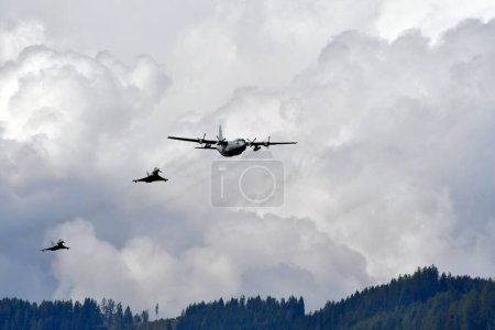 Photo for Zeltweg, Austria - September 03, 2022: Public airshow in Styria named Airpower 22, display with Hercules C130 and two Eurofighter Typhoon from Austrian air force - Royalty Free Image