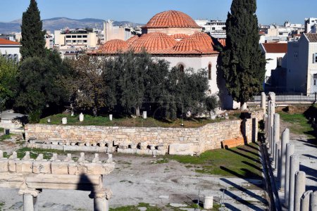 Athens, Greece - December19, 2023: Ruins in the ancient Roman Agora in Plaka district with Fethije Mosque