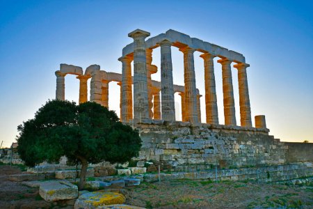 Lavrio, Greece - December 19, 2023: The ancient Temple of Poseidon in the light of the setting sun