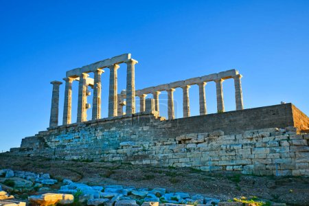 Lavrio, Greece - December 19, 2023: The ancient Temple of Poseidon in the light of the setting sun