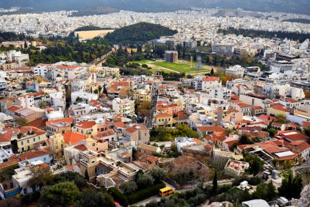 Athens, Greece - December 20, 2023: View from the Acropolis over the city's sea of houses with the ancient Hadrian's Gate, the Olympion and the Panathenaic Stadium