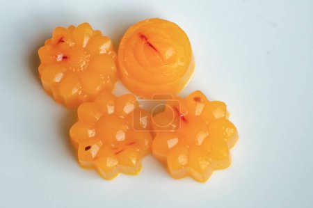 Photo for Close up shot of four vegan orange and saffron flower shaped agar jellies - Royalty Free Image