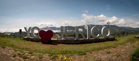 Photo for Wide Angle Shot of Big Letters That Read "I Love Jerico" in Spanish on a Path on a Hill Against Beautiful Mountain Landscape with Clouds - Royalty Free Image