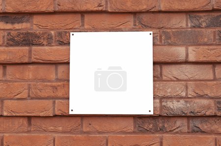 White empty square sign on a red brick wall. copy space, place for text