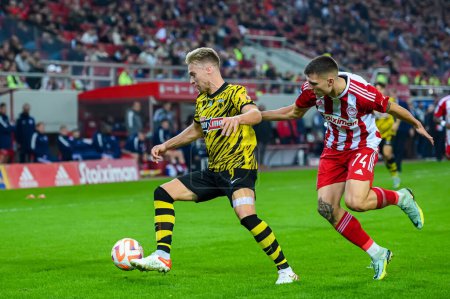 Photo for 9 TOM VAN WEERT&#xA;of AEK FC competing with 74 ANDREAS NTOI&#xA;of Olympiacos FC during Matchday 13, Greek Super League match between Olympiacos FC vs AEK FC at the Karaiskakis Stadium on November 13, 2022 in Athens, Greece. - Credit: Stefanos Kyria - Royalty Free Image