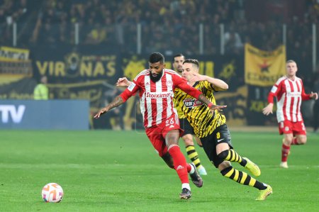 Photo for 23 RODINEI of Olympiacos FC competing with 8 MIJAT GA?INOVI? of AEK FC during the Greek Super League, Matchday 26, match between AEK FC and Olympiacos FC at OPAP Arena on March 12, 2023, in Athens, Greece. - Credit: Stefanos Kyriazis/LiveMedi - Royalty Free Image