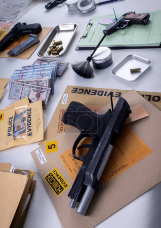 Money and weapons in crime lab for investigation, conceptual image