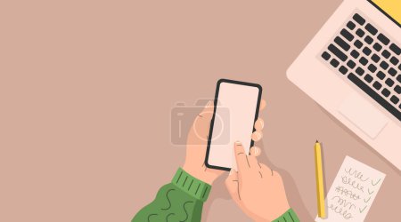 Illustration for Human holds a smartphone in his hands over a table with a laptop and a notebook. Office work concept. Flat design. Vector illustration - Royalty Free Image