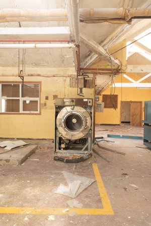 Photo for Image of an industrial washing machine in a Laundry-room, in an abandoned, derelict, Hospital. - Royalty Free Image