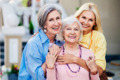 Group of beautiful and happy senior adult women dating outdoors and meeting in the city - Stylish fashionable old mature people social gathering and having fun in a cafe Poster #617267080