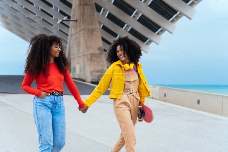 Photo for Young happy women having fun outdoor , laughing and sharing good mood. Teenagers girls walking at the harbor in Barcelona after school - Royalty Free Image