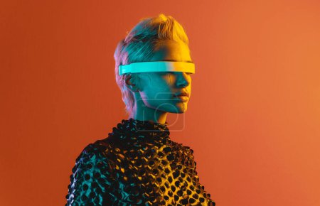Photo for Representation of a bionic super human with advanced technology parts as vr visors and gadgets playing in a mixed reality training room. Futuristic cyberpunk evolution of human mankind and AI - Royalty Free Image