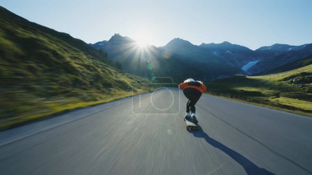Photo for Cinematic downhill longboard session. Young woman skateboarding and making tricks between the curves on a mountain pass. Concept about extreme sports and people - Royalty Free Image