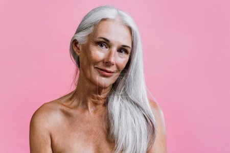Photo for Image of a beautiful senior woman posing on a beauty photo session. Middle aged woman on a colored background. Concept about body positivity, self esteem and body acceptance - Royalty Free Image