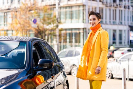 Photo for Beautiful young woman with short hair driving car in the city - Pretty caucasian female adult business woman wearing elegant suit going to work in the office - Royalty Free Image