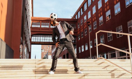 Photo for Image of a businessman and soccer freestyle player making tricks with the ball on the street. Concept about sport and business people - Royalty Free Image
