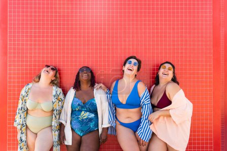 Photo for Group of beautiful plus size women with swimwear bonding and having fun at the beach - Group of curvy female friends enjoying summertime at the sea, concepts about body acceptance, body positive and self confidence - Royalty Free Image