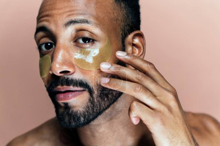 Photo for Image of a young man taking care of his skin. Beauty studio shot about skin care and products for the personal hygiene. - Royalty Free Image