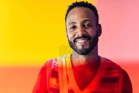 Photo for Image of an handsome young man posing on colored backgrounds wearing colorful trendy clothes. Concept about carefree, fashion and lifestyle - Royalty Free Image