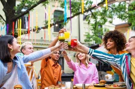 Photo for Multiracial young people together meeting and having party in a restaurant - Group of friends with mixed races having fun celebrating in a bar- Friendship and lifestyle concepts - Royalty Free Image