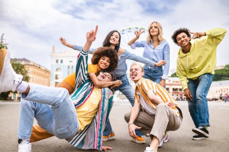 Photo for Multiracial young people together meeting and social gathering - Group of friends with mixed races having fun outdoors in the city- Friendship and lifestyle concepts - Royalty Free Image