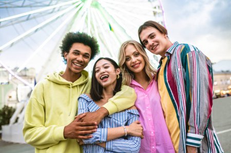 Photo for Multiracial young people together meeting and social gathering - Group of friends with mixed races having fun outdoors in the city- Friendship and lifestyle concepts - Royalty Free Image