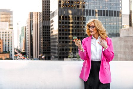 Photo for Transgender business woman lifestyle moments in downtown, Los angeles. Lgbt woman going to work at  the office. Representation of equality and working rights for the lgbtq+ community. - Royalty Free Image