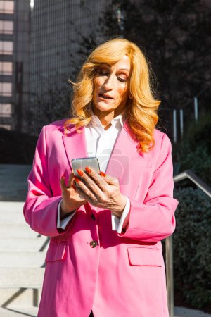 Photo for Transgender business woman lifestyle moments in downtown, Los angeles. Lgbt woman going to work at  the office. Representation of equality and working rights for the lgbtq+ community. - Royalty Free Image