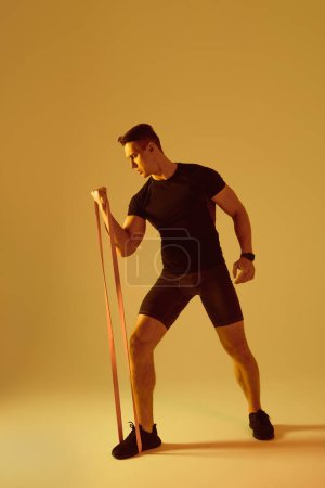 Photo for Athletic man with fit muscular body training in studio - Active man doing a workout, colorful lighting and background, concepts about fitness, sport and health lifestyle - Royalty Free Image
