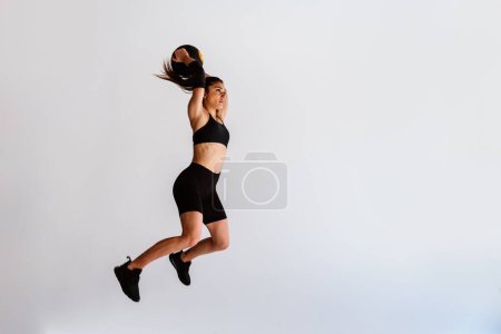 Photo for Young female athlete training in a gym using sport equipment. Fit woman working out . Concept about fitness, wellness and sport preparation. - Royalty Free Image
