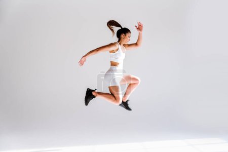 Photo for Young female athlete training in a gym using sport equipment. Fit woman working out . Concept about fitness, wellness and sport preparation. - Royalty Free Image