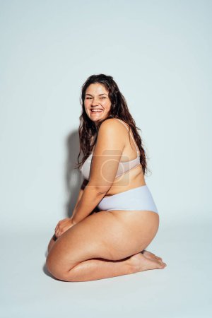 Photo for Plus size woman posing in studio in lingerie. Model on white background. Hard light studio shot - Royalty Free Image