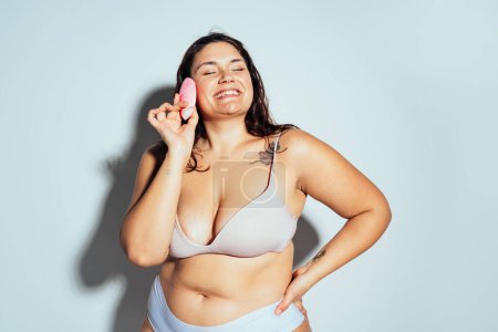Foto de Mujer de talla grande posando en estudio en lencería. Modelo sobre fondo blanco. Tiro de estudio de luz dura - Imagen libre de derechos