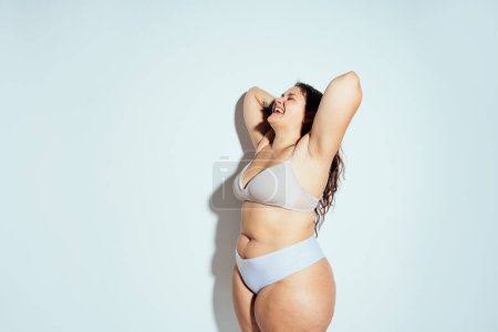 Photo for Plus size woman posing in studio in lingerie. Model on white background. Hard light studio shot - Royalty Free Image