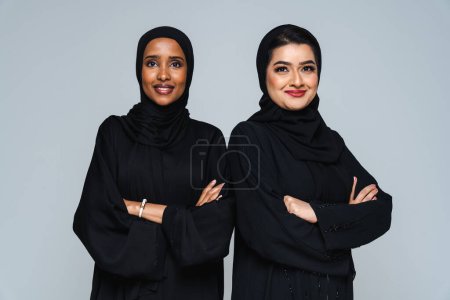 Photo for Beautiful arab middle-eastern women with traditional abaya dress in studio - Arabic muslim adult female portrait in Dubai, United Arab Emirates - Royalty Free Image