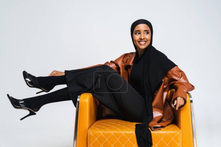Photo for Beautiful arab middle-eastern woman with traditional abaya dress in studio - Black african muslim adult female wearing fashionable and stylish arabic dress portrait in Dubai, United Arab Emirates - Royalty Free Image