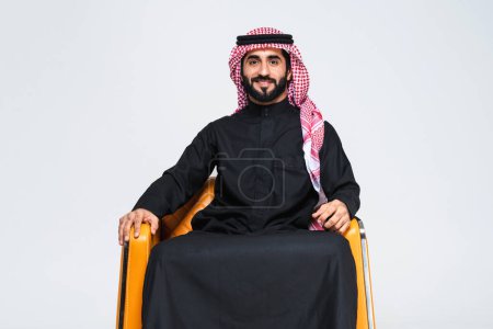 Photo for Handsome arab middle-eastern man with traditional saudi clothing in studio - Arabic muslim adult male businessman wearing thwab portrait isolated on gray background - Royalty Free Image
