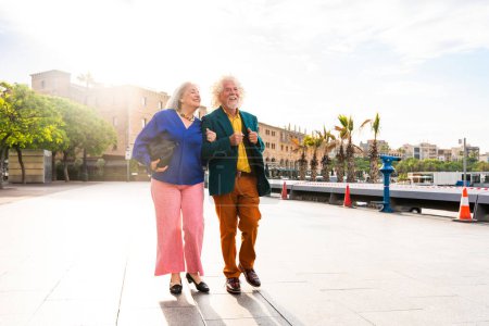 Photo for Senior couple of old people dating outdoors - Married elderly man and woman in love spending time together - Grandparents having fun strolling in the city - Royalty Free Image