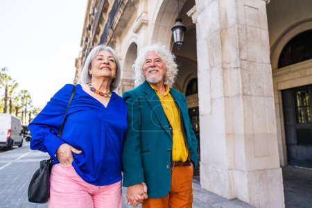 Photo for Senior couple of old people dating outdoors - Married elderly man and woman in love spending time together - Grandparents having fun strolling in the city - Royalty Free Image