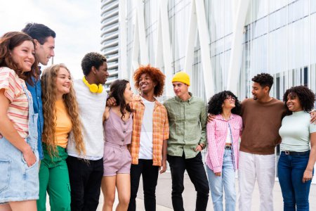 Photo for Happy playful multiethnic group of young friends bonding outdoors - Multiracial millennials students meeting in the city, concepts of youth, people lifestyle, diversity, teenage and urban life - Royalty Free Image