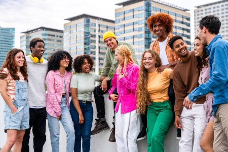 Foto de Feliz grupo multiétnico juguetón de jóvenes amigos que se unen al aire libre - Multiracial millennials estudiantes que se reúnen en la ciudad, conceptos de juventud, estilo de vida de las personas, diversidad, la vida adolescente y urbana - Imagen libre de derechos