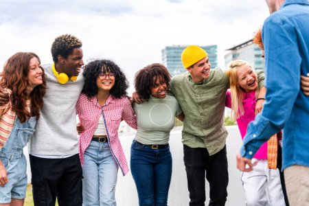 Photo for Happy playful multiethnic group of young friends bonding outdoors - Multiracial millennials students meeting in the city, concepts of youth, people lifestyle, diversity, teenage and urban life - Royalty Free Image