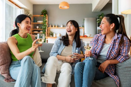 Photo for Happy beautiful chinese women friends bonding at home - Playful pretty asian female adults meeting and having fun at home, concepts about lifestyle, domestic life and friendship - Royalty Free Image