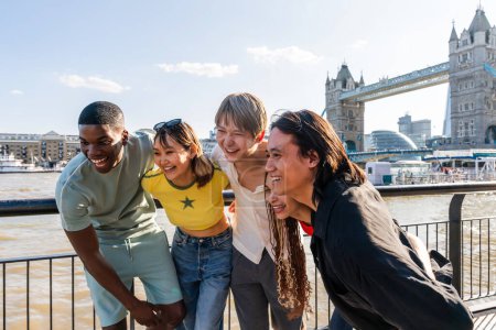 Photo for Multiracial group of happy young friends bonding in London city - Multiethnic teens students meeting and having fun in Tower Bridge area, UK - Concepts about youth lifestyle, travel and tourism - Royalty Free Image