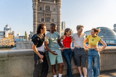 Photo for Multiracial group of happy young friends bonding in London city - Multiethnic teens students meeting and having fun in Tower Bridge area, UK - Concepts about youth lifestyle, travel and tourism - Royalty Free Image