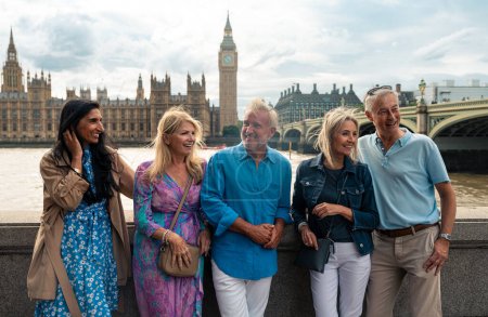 Photo for Group of old friends spending time together in the main parts of london, visiting the westminster area and st. james park. Old buddies reunion. Concept about third age and seniority - Royalty Free Image