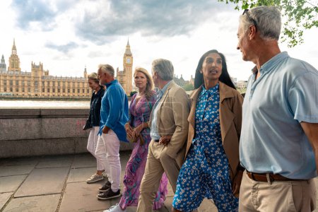 Photo for Group of old friends spending time together in the main parts of london, visiting the westminster area and st. james park. Old buddies reunion. Concept about third age and seniority - Royalty Free Image