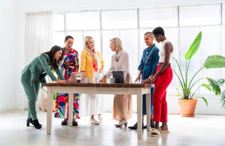Téléchargez les photos : Groupe de belles femmes d'affaires confiantes se réunissant dans le bureau - Multiethinc équipe créative féminine remue-méninges au travail - Divers collègues travaillant ensemble en atelier dans un espace de co-travail - en image libre de droit