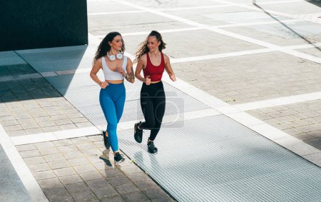 Photo for Lgbt couple training together outdoor. Runner real couple making sport in an urban area of the city. Concepts of sports and lifestyle - Royalty Free Image